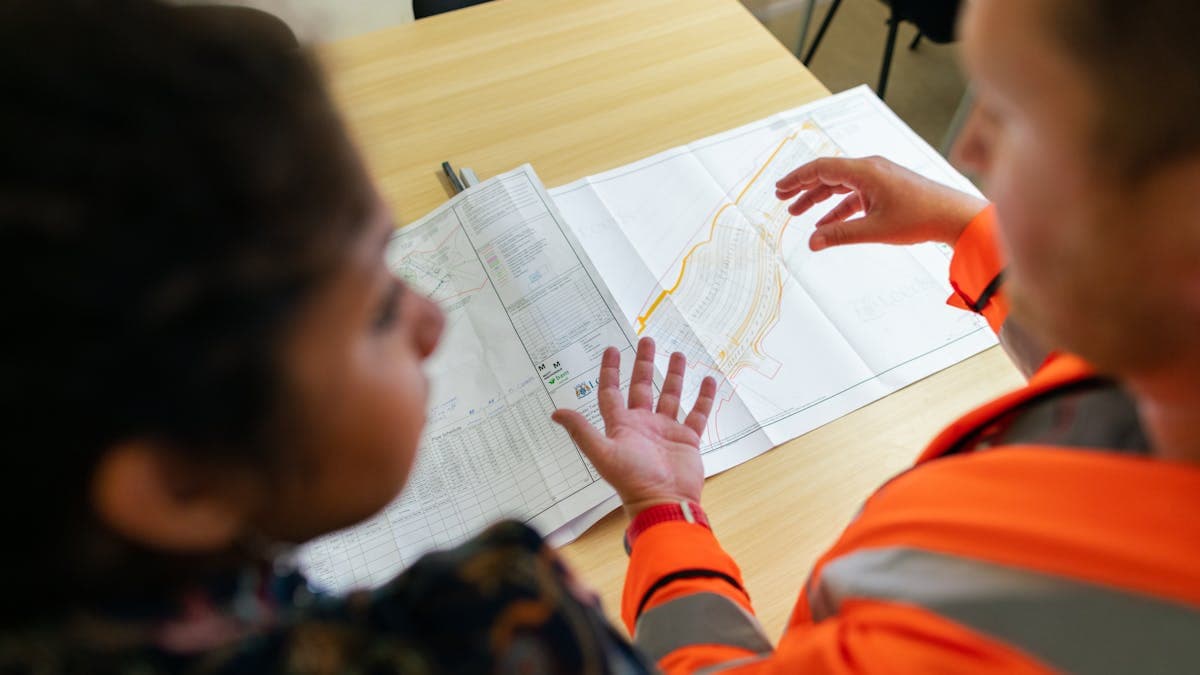 Engineers reviewing blueprints — general contractor vs specialized builder comparison