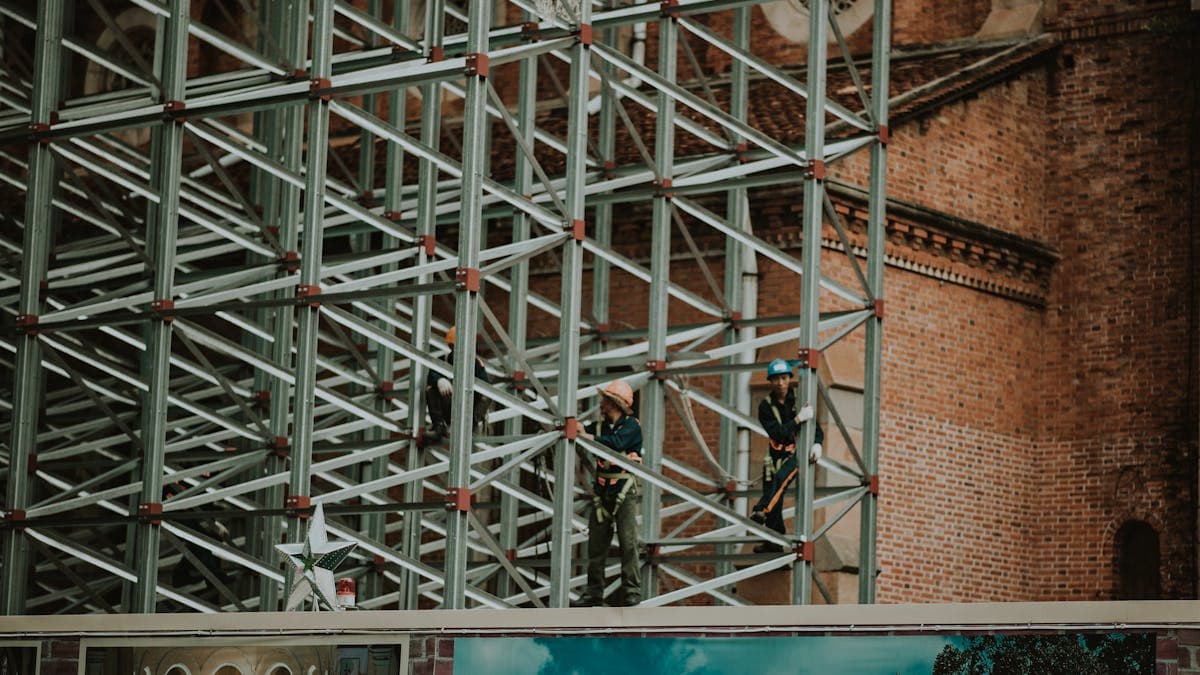 Construction scaffold on NYC brick building — Local Law 11 compliance for property owners