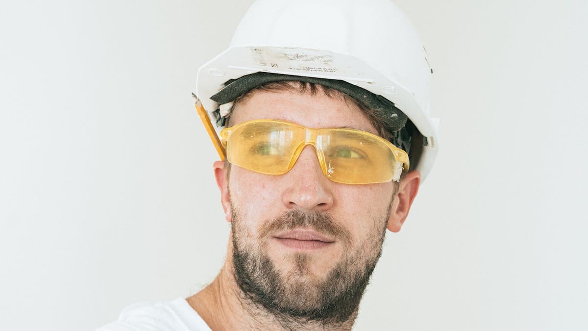 Construction worker with hard hat on NYC job site — hiring a general contractor
