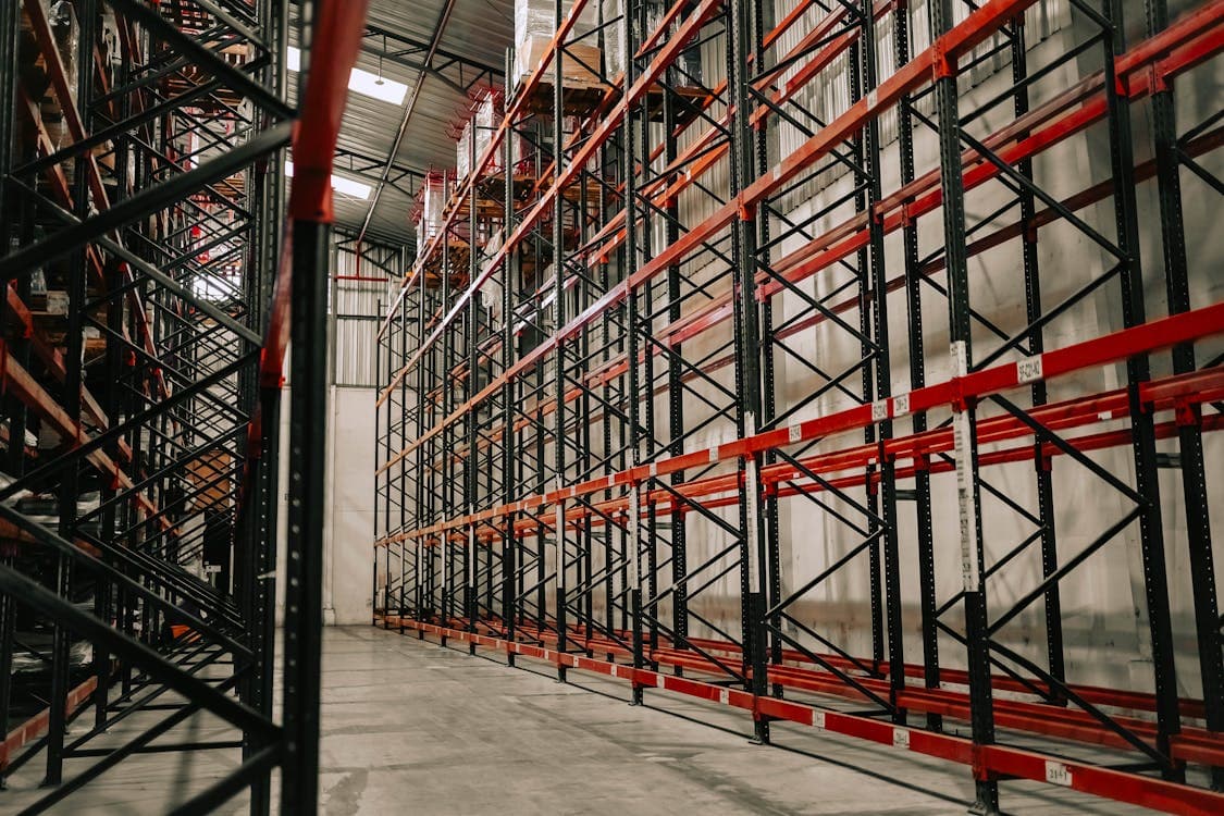 Spacious warehouse with empty metal racks